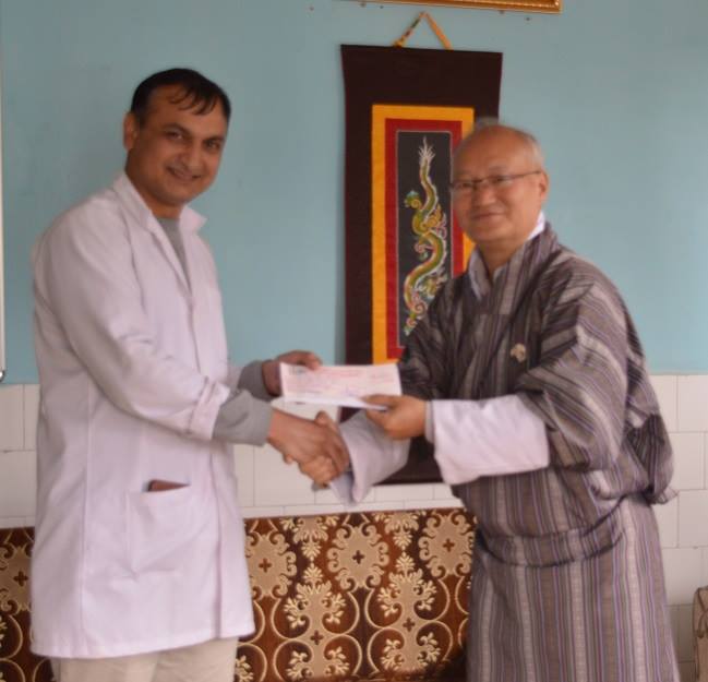 Dr. Tika Ram Adhikari, ENT Specialist, JDWNRH, Thimphu Receiving the Research Grant from the Hon’ble, President KGUMSB
