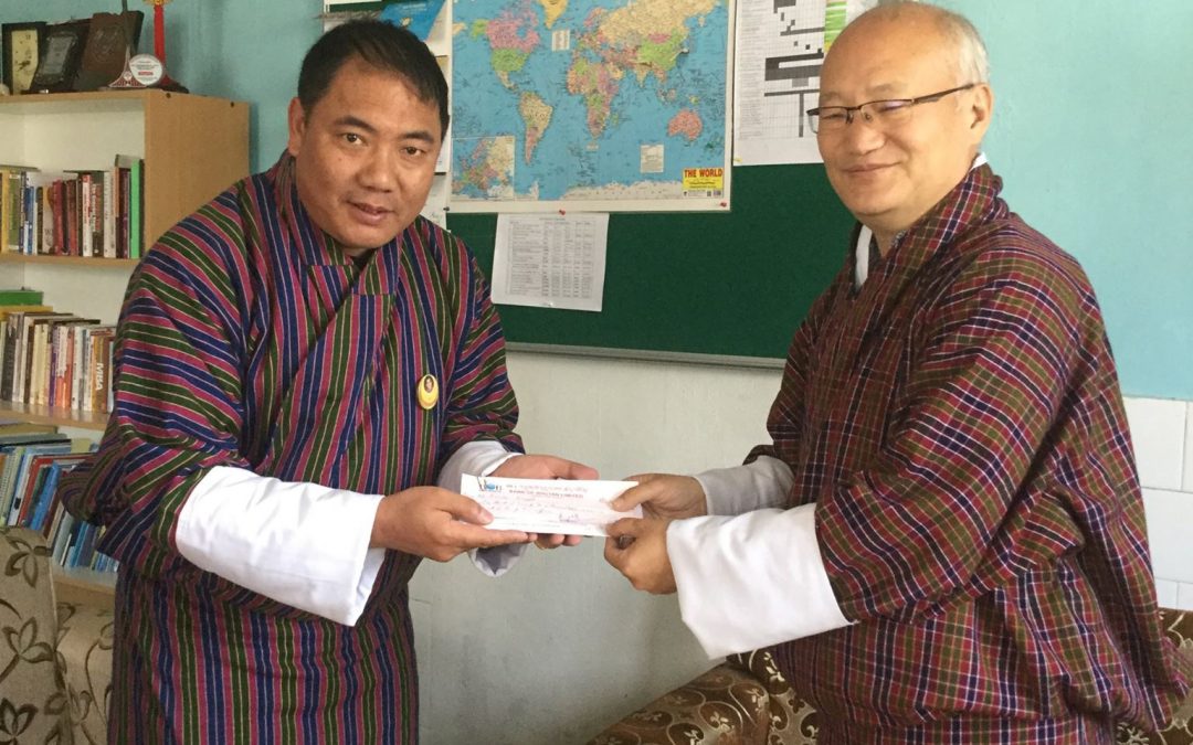 Mr. Kencho Wangdi receiving the research grant from the Hon’ble President, KGUMSB